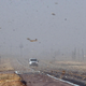 Debris from nearby farm fields swirls around on Highway 400 between Mullinville, Kansas, and Dodge City.